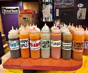 Hot sauce bottles lined up on a table